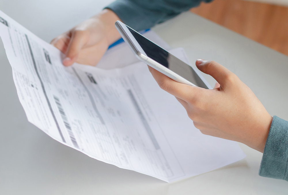 man looking at his heating bill after changing it 1 degree