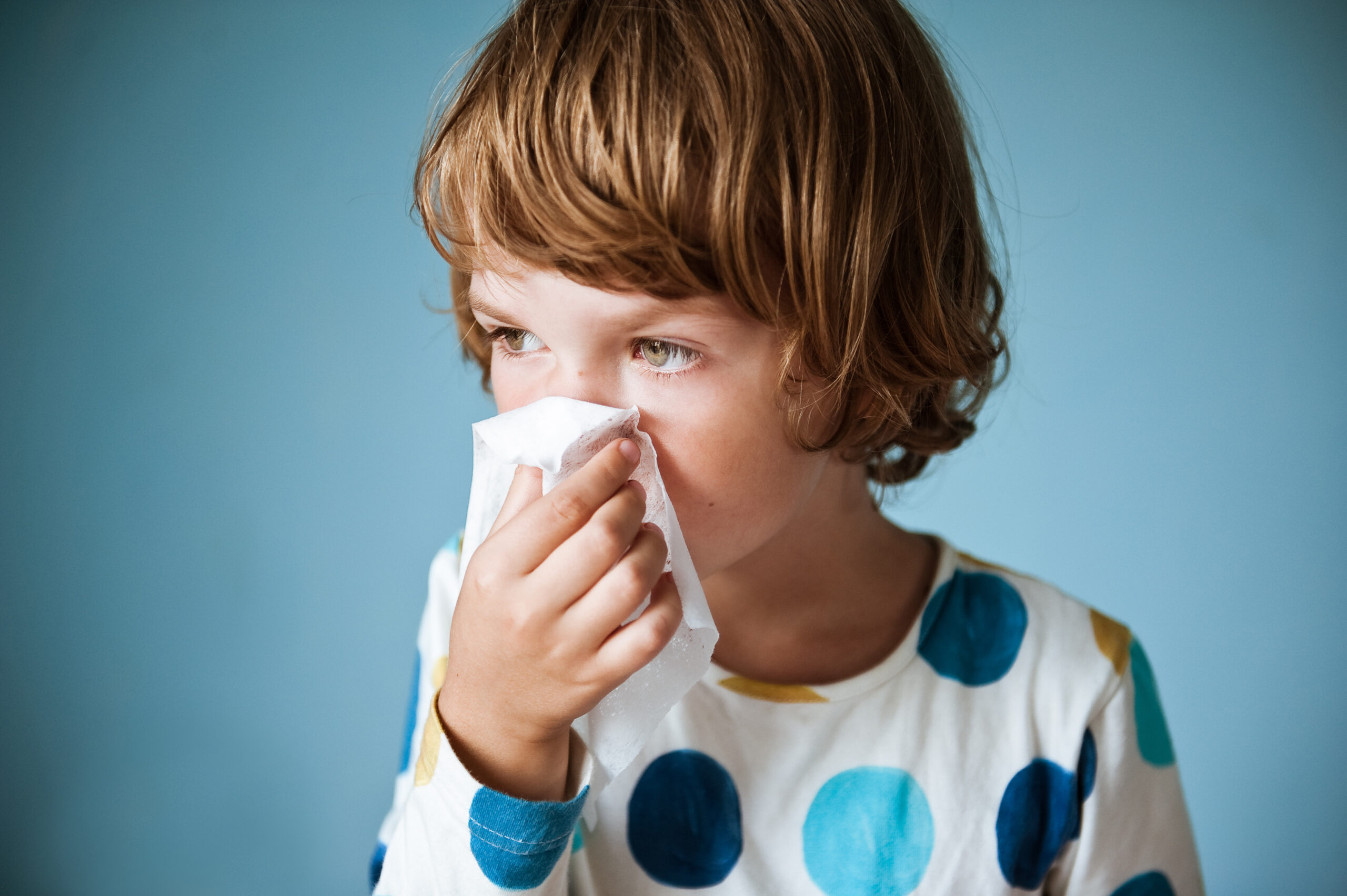 kid blowing their nose