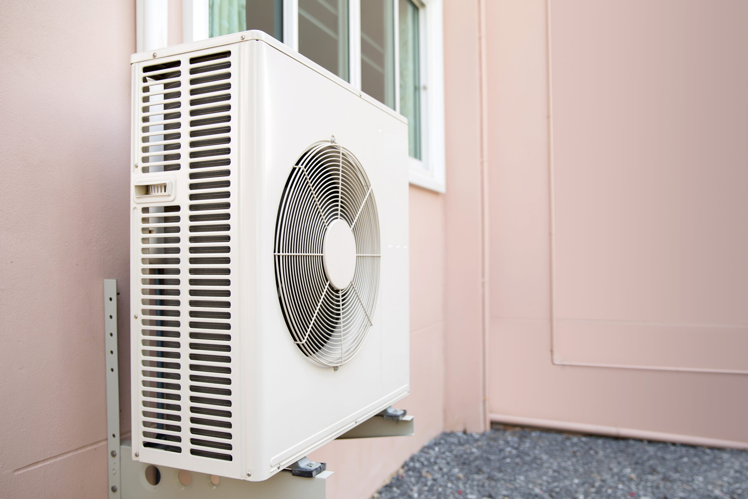 heat pump mounted on the side of a house