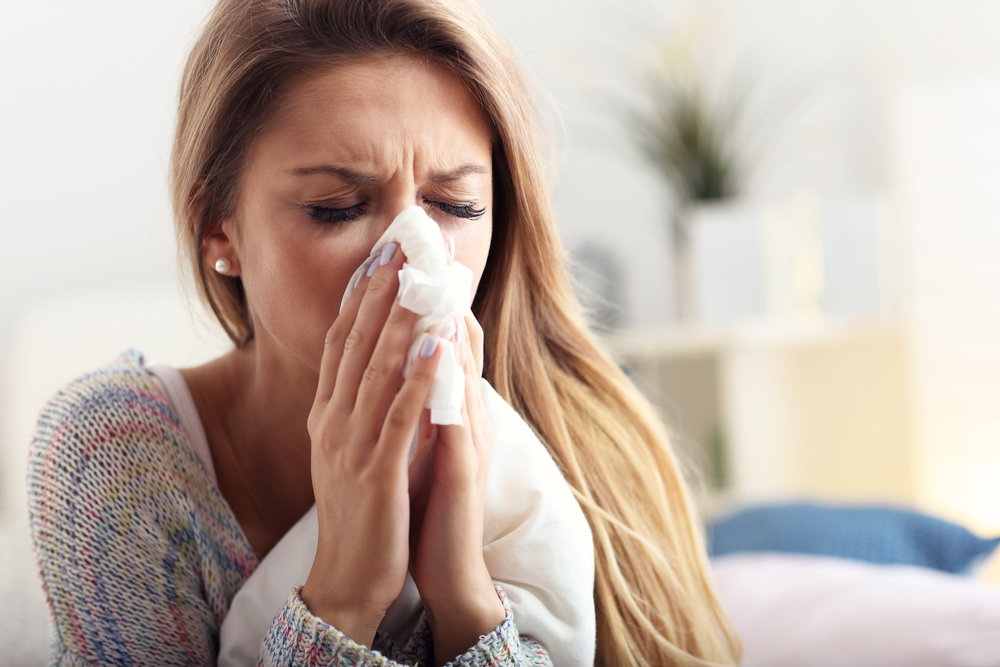 woman blowing her nose